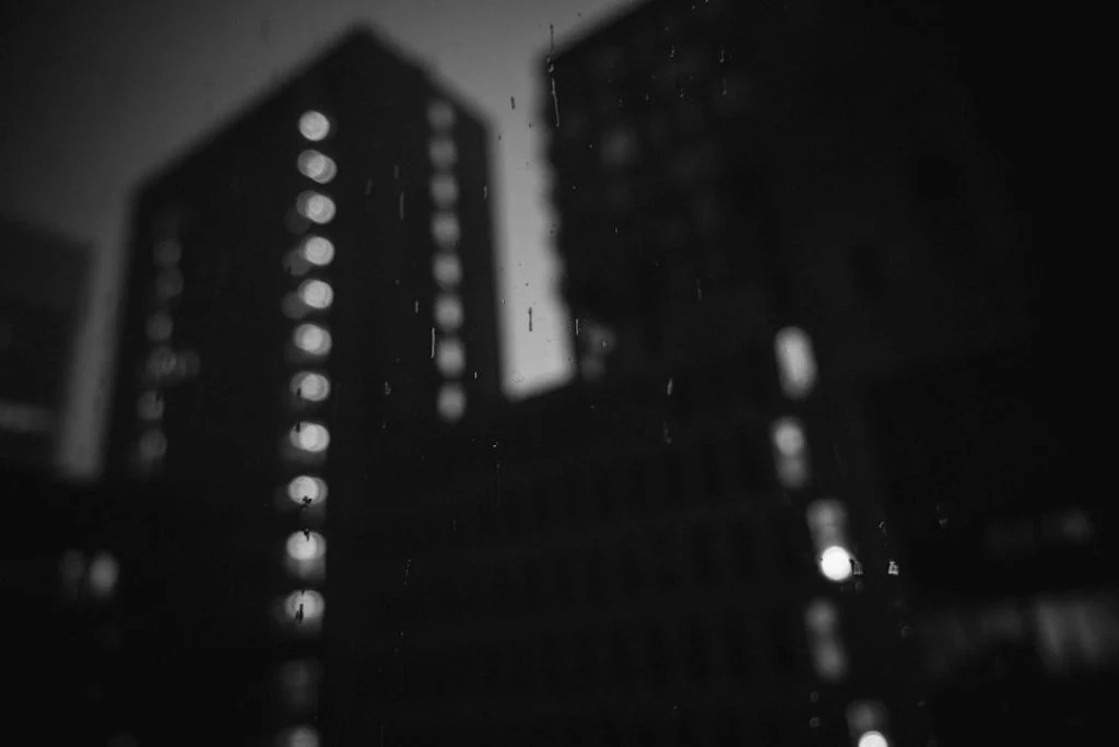 Black and white rainy city at night evoking the noir atmosphere of Spider-Noir on Prime Video